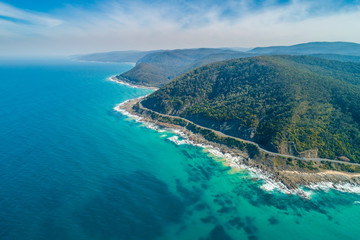 Aerial landscape of Great Ocean Road and scenic green hills on sunny day in Victoria, Australia
