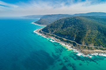 Aerial landscape of Great Ocean Road and scenic green hills on sunny day in Victoria, Australia