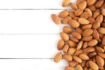 Pile of almond nuts on wood table,Top view.