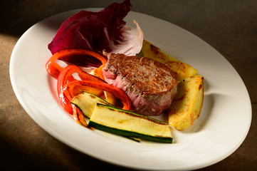 roasted beef steak with vegetable decorated and searved on a plate