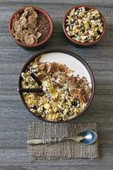 Healthy breakfast bowl with muesli, seeds and chocolate sticks. Sample breakfast for the figure and beauty.