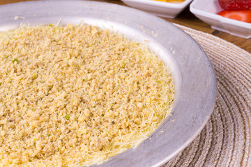 Turkish dessert kunefe, kunafa, kadayif with pistachio powder and cheese hot eaten a sweet