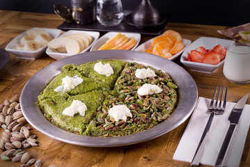 Turkish dessert kunefe pistachio with fresh fruits and milk