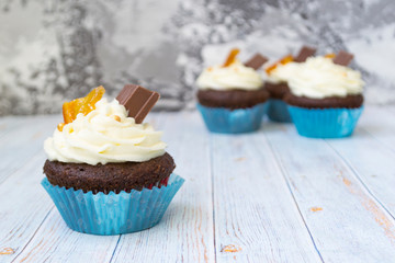 Chocolate cupcakes with vanilla butter frosting and golden crumbs, chocolate, and lemon. There is a memo for the text.