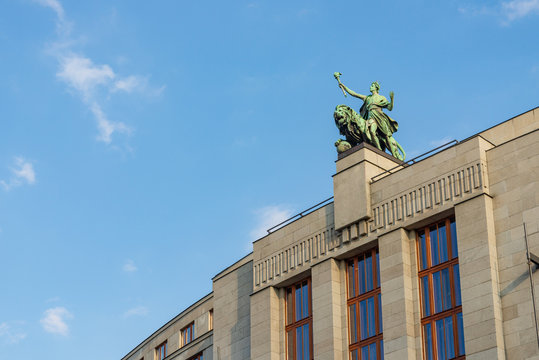 Low angle view of the bronze statue and sculpture on the top of banking tower in Prague, Czech Republic.