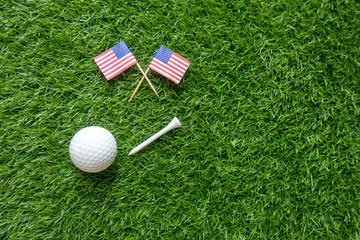 Golf ball with flag of American flag on green grass 4th July