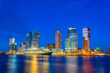 Fotobehang Night view of Holland america line building and other skyscrapers in Rotterdam, Netherlands © dudlajzov