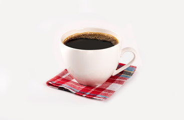 Cup of coffee on colorful place mat on white background