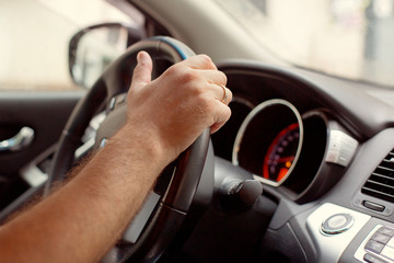 Man driver hands holding the car steering panel. Male hand using a car automatic gear. Driving automobile with automatic gears concept