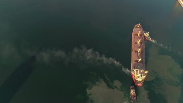 Aerial view on Cargo Ship Polluting Air With Smoke