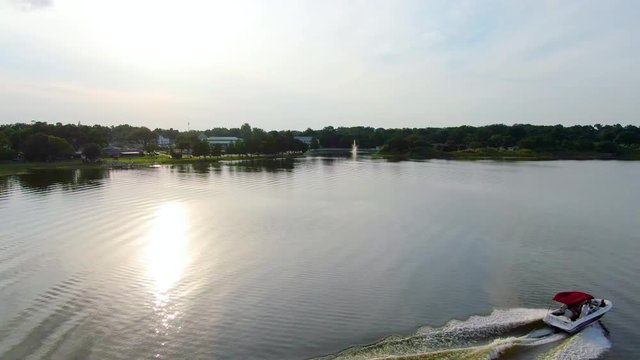 Flying over a boat in a beautiful Central Florida lake during sunset