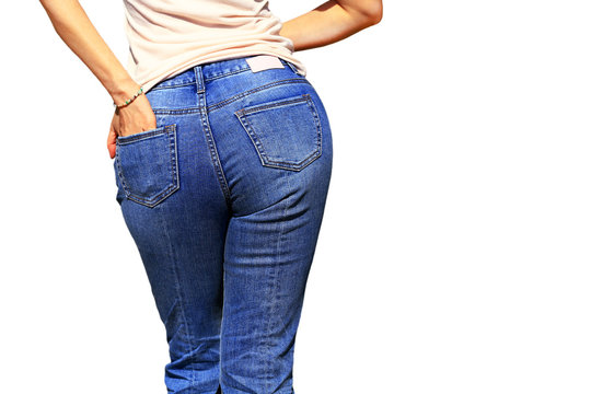 Sexy woman wearing of jean pants from back. Female bottom in tight jeans isolated on white background. 