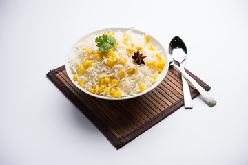 Corn Rice made using boiled Maize seeds with basmati rice, served in a bowl. selective focus 