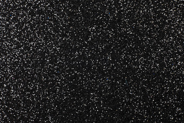 Black foam surface with glitter.