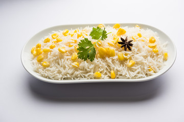 Corn Rice made using boiled Maize seeds with basmati rice, served in a bowl. selective focus 
