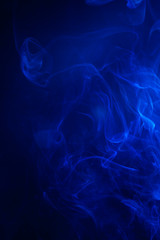 Blue smoke on black background.