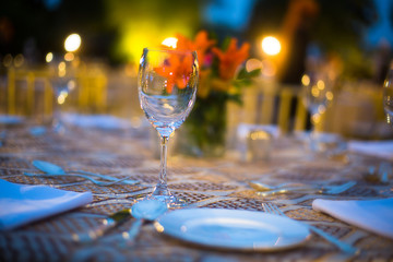 Royal dining setup with beautiful plates and glasses on the table, destination wedding dinner - Image
