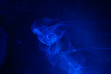 Blue smoke on black background.