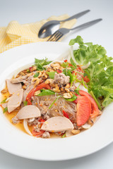 Close up Thai spicy vermicelli salad with minced pork and pork sausage on white dish
