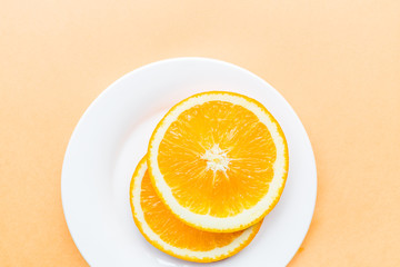 Sliced orange lying on white plate, Popular healthy fruit. Flat lay photography, Top view, overhead