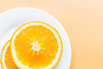 Sliced orange lying on white plate, Popular healthy fruit. Flat lay photography, Top view, overhead