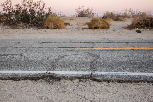 Abandoned and Cracked Desert Road at Sunset - Powered by Adobe
