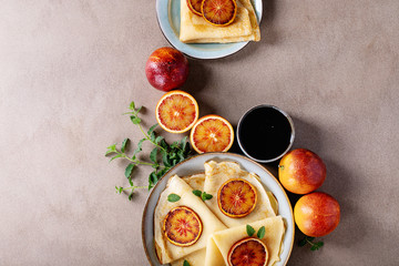 Homemade pancakes served with fried blood oranges