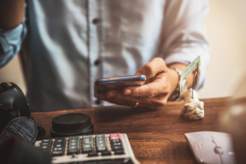 Man using mobile in coffee shop reading chat message social network