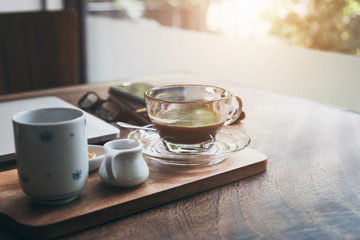 Coffee cup and tea put on wooden table with nature background