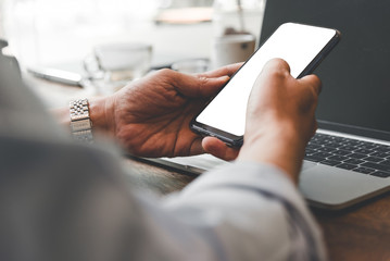 Business man using mobile and laptop find a job in coffee shop