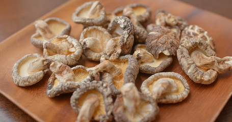 Stack of dry mushroom on wooden plate