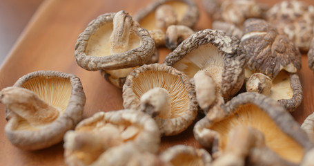 Stack of dry mushroom on wooden plate