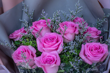 Pink roses flower bouquet with water drops at the flower market.Selective focus beautiful flower background.