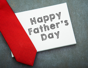 Fototapeta na wymiar Happy Father's Day Text with Tie Over White Board