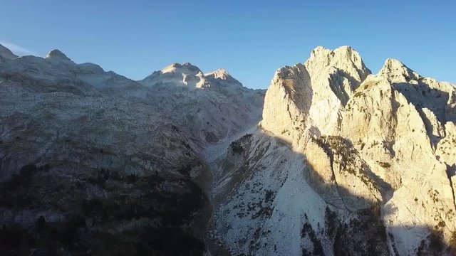 Mountain summit in the Albanian Alps hiking between Valbone and Theth in Albania during sunset.