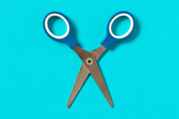 Scissors on blue background. Colored baby scissors.