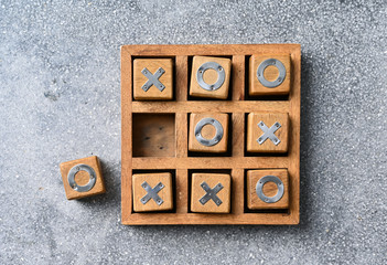 Wooden tic tac toe (O X) game. The concept of business strategy and competition 