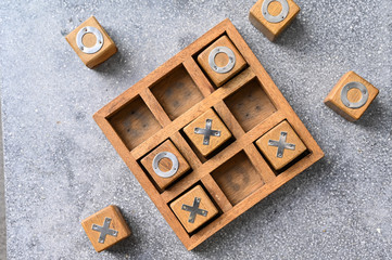 Wooden tic tac toe (O X) game. The concept of business strategy and competition 