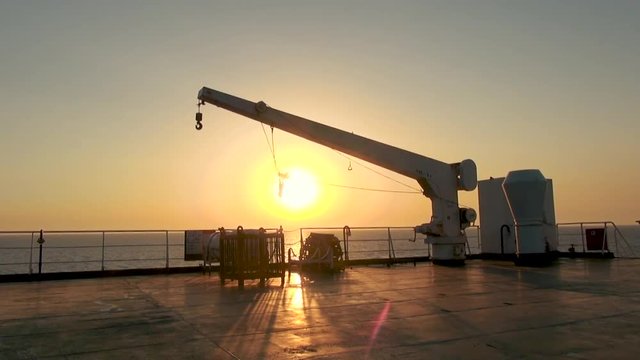 Farry or Ship Crane at Sunset. Sea in the Background.