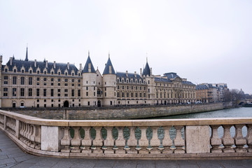 Fototapeta na wymiar View of the Castle Conciergerie, formerly royal palace and prison, presently it is part of complex Palais de Justice in Paris on a cloudy winter day, France