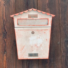 old mailbox on brick wall