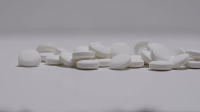 Bottle of pills spill out of prescription bottle.