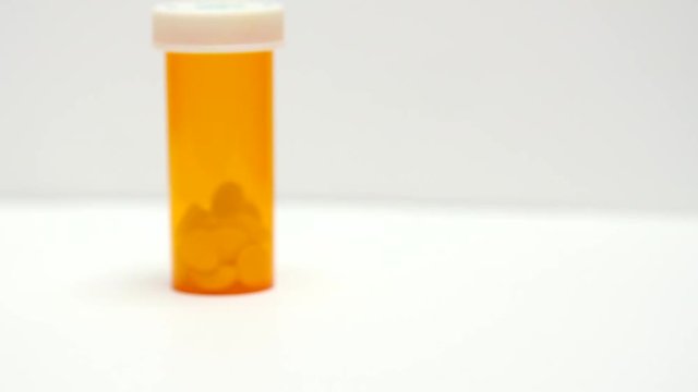 Two pill bottles sit on white counter.