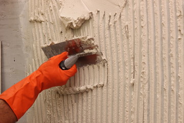 Tile setting with a trowel