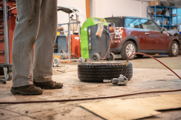 Repair and check car in repair shop. An experienced technician repairs the faulty part of the car. I change tires