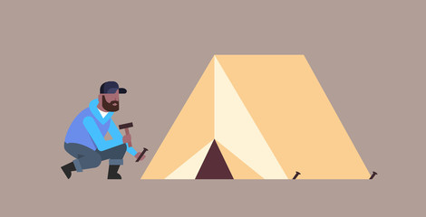 Fototapeta premium man hiker camper installing a tent preparing for camping hiking concept african american traveler on hike horizontal male cartoon character full length flat
