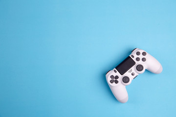 Joystick gaming controller isolated on blue background , Video game console developed Interactive Entertainment