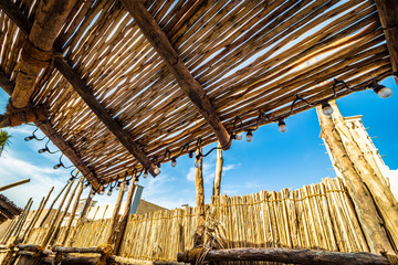 Fototapeta na wymiar Canopy and reed fence in a rural area.