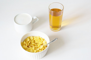 Healthy breakfast with cornflakes and milk over white background