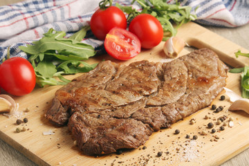 A beef steak well done with vegetables